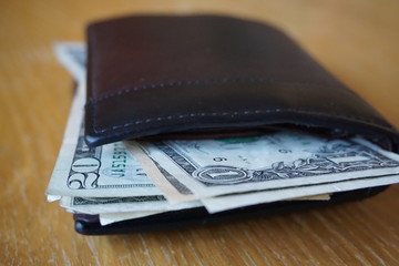 Detail of the American money (USD, US, US dollars), bank notes inserted in the leather wallet