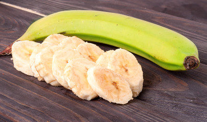 sliced banana with green on  wooden board