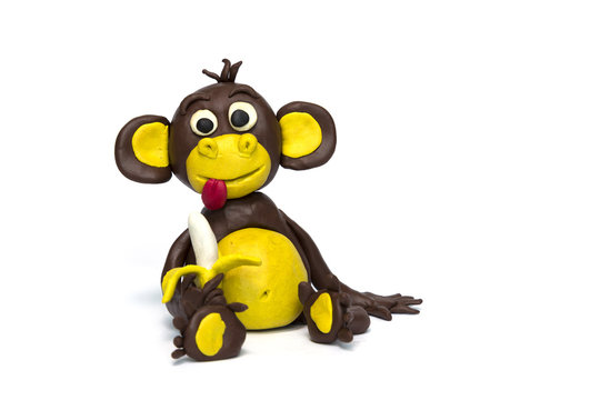 Handmade plasticine monkey on white background