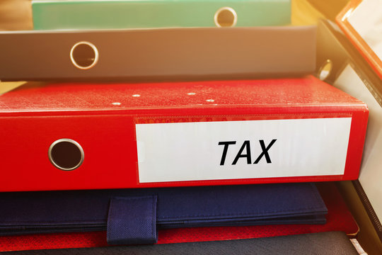 Pile up document file or binder with text tax