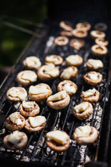 Champignon white mushrooms grilled on grill or BBQ steam