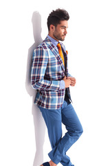 man standing with legs crossed in studio