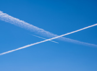 Vapor trails into the blue sky