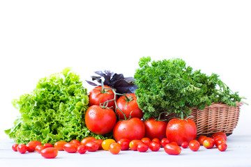 Fresh tomatoes and various herbs.