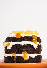 Chocolate cake with oranges on the wooden background