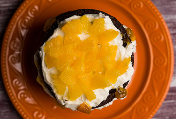 Chocolate cake with oranges on the wooden background