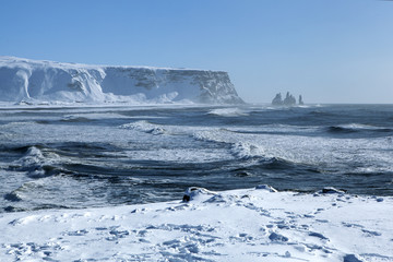 Wide lens capture of the three pinnacles of Vik, Iceland in wint