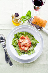 dish with Italian food, ravioli or tortelli on the table. cheese