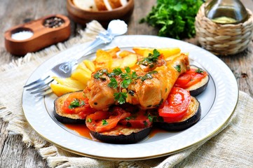 Braised chicken in white wine with eggplant, tomato and french fries.