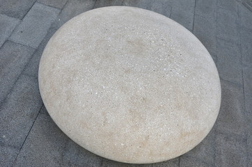 Big off white round polished pebble on brick floor
