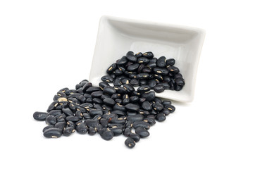 Fototapeta na wymiar spill beans of black bean on white isolated
