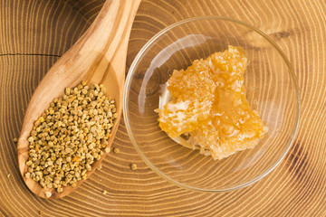 Fresh bee pollen in the spoon with honeycomb