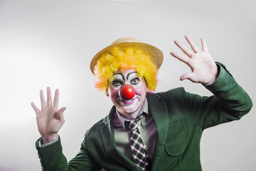 the clown joyfully waving his hands in greeting
