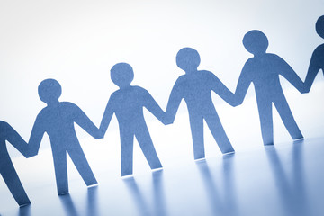 Paper people standing together hand in hand. Team, society, business concept