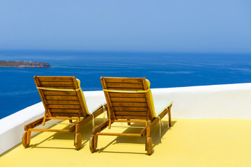 Big lounge chairs with sea view in Oia, Santorini, Greece