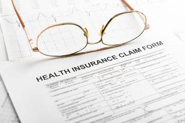 Health insurance claim form with glasses