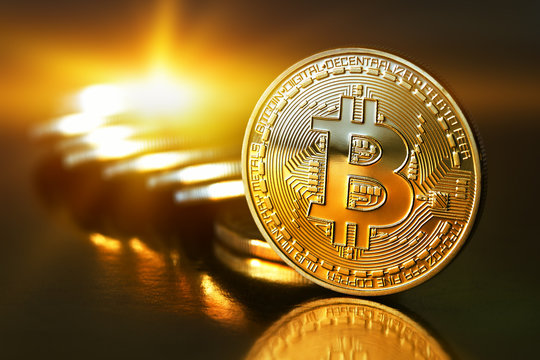 Golden Bitcoins on a gold background .Photo (new virtual money )