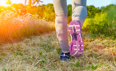 Woman running at sunset in a field