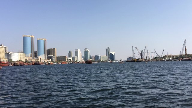 DUBAI - NOVEMBER 22, 2015: Dubai Creek with tourists on a beautiful day. The city attracts 14 million worldwide visitors each year