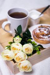 close up of wooden tray with breakfast and flowers