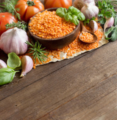 Red lentils in a bowl with tomatoes, garlic and herbs