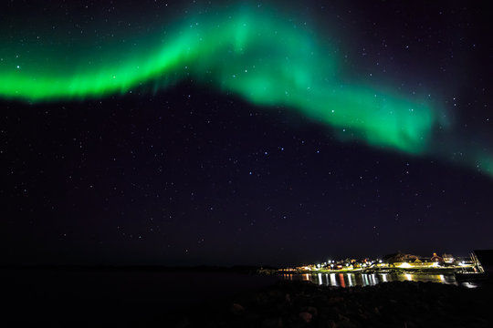 Northern lights over the old harbor of Nuuk city