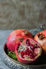 Juicy pomegranates in a vintage plate