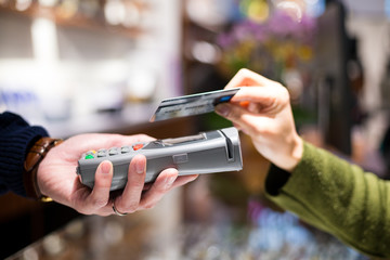 Woman paying with NFC technology on credit card