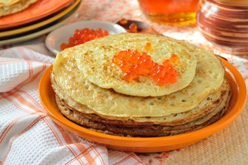 Pancakes with red caviar. Pile of pancakes on a plate