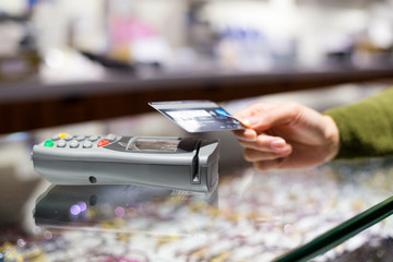 Woman paying with NFC technology on credit card