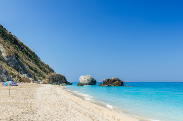 Fototapeta na wymiar Wild beach of Megali Petra. A beautiful beach with large rocks in the water. Megali Petra Beach, Lefkada Island, Levkas, Lefkas, Ionian sea,