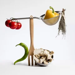 Fotobehang concept of sophisticated gastronomy with gourmet food ingredients playing with cuisine utensils for fun health and vegetable design on white background © STUDIO GRAND WEB
