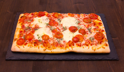 Pizza on plate slate on wooden table