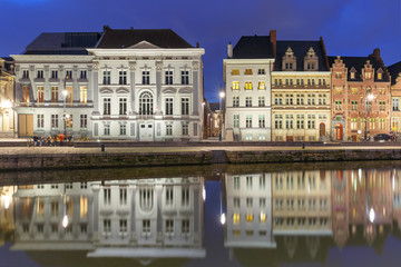 Fototapeta na wymiar Picturesque medieval building on the quay Korenlei with reflections in Ghent town at night, Belgium