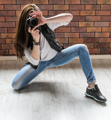 smiling girl taking photo with dslr camera in funny positions