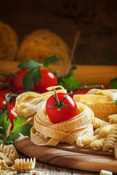 Dry italian pasta in assortment, cherry tomatoes, parsley, selec