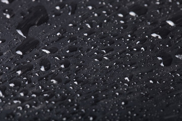 Drops of water on a color background. Black. Shallow depth of fi