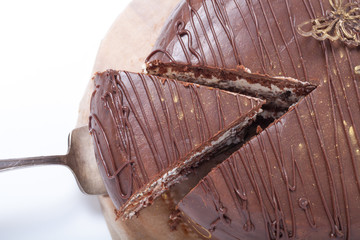 Chocolate homemade cake with gold decor. Close up