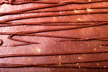 Chocolate homemade cake with gold decor. Close up. Toned