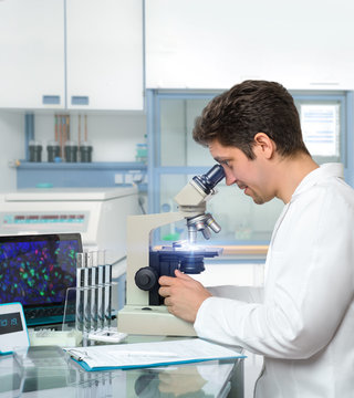 Male scientist or tech works with microscope