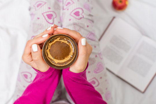 Woman Having A Cup Of Coffee In Bed