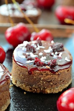 sweet chocolate desserts with frosting and cherries.