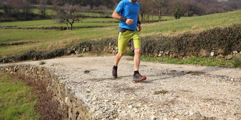 sportsman with running shoes runs during cross country race