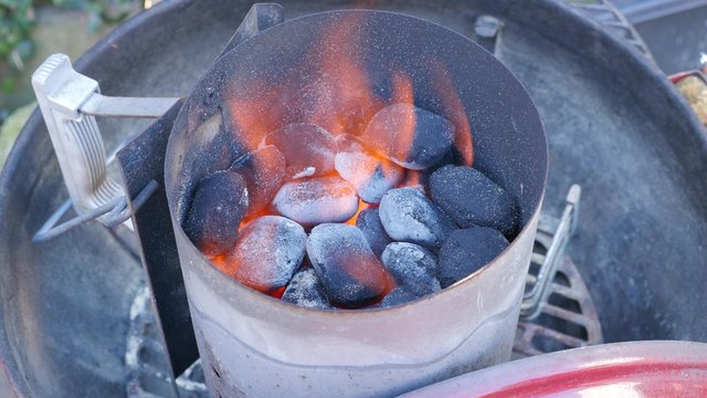 BBQ firestarter with coals in it and flames