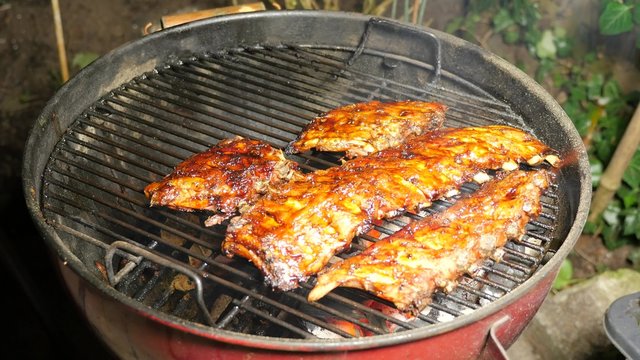 BBQ spicy marinated and smoked pork spareribs on the hot charcoal grill