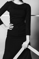 Girl holds in her hands frame, black and white photo, studio sho