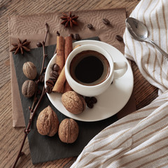 A cup of hot coffee and themed items around it.