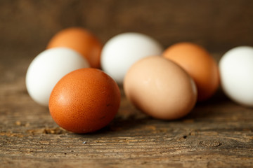 Chicken eggs on a wooden rustic background