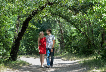 Fototapeta premium young pretty couple in the green summer park