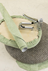 upholstering a part of chair by staple gun
